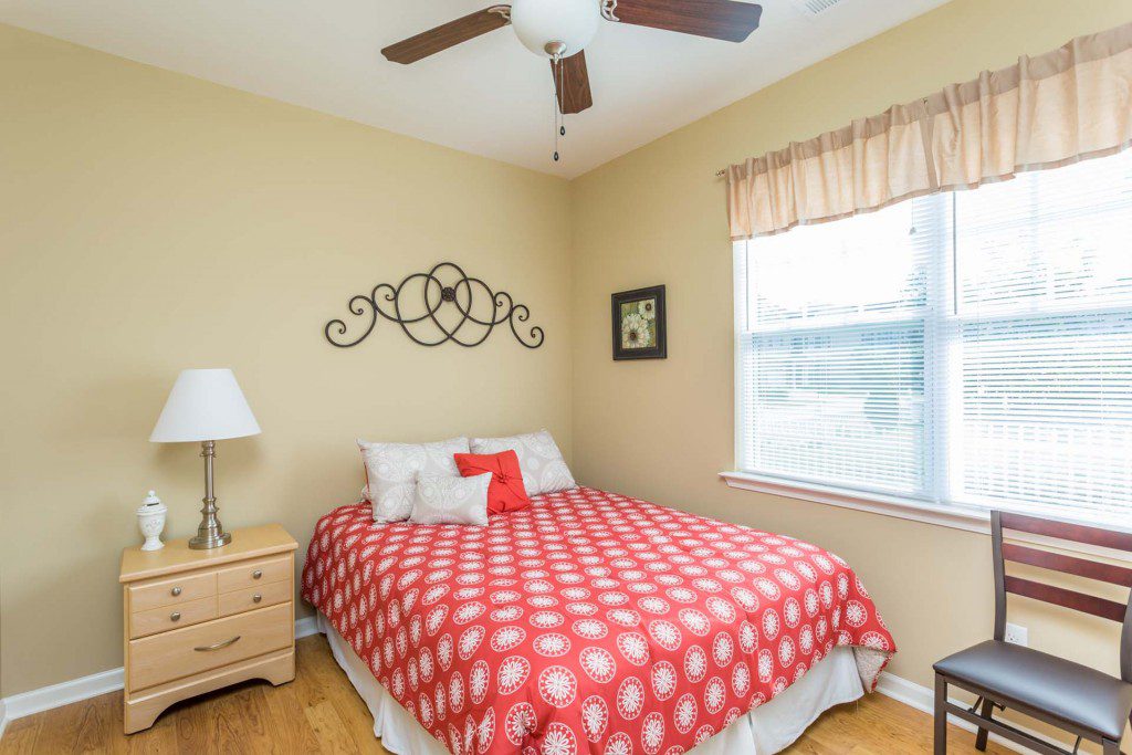 Bright resident bedroom with a large window at Avendelle at Lazy River